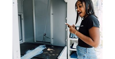 TikToker Gabby Morrison watching the Future Finish laser technology process create her customized pair of light wash Levi's® jeans.