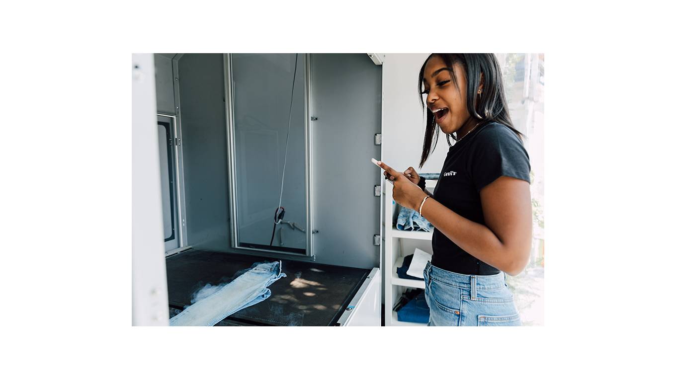 TikToker Gabby Morrison watching the Future Finish laser technology process create her customized pair of light wash Levi's® jeans.