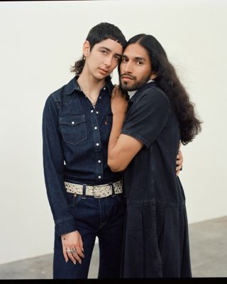 to people standing close together wearing dark clothing