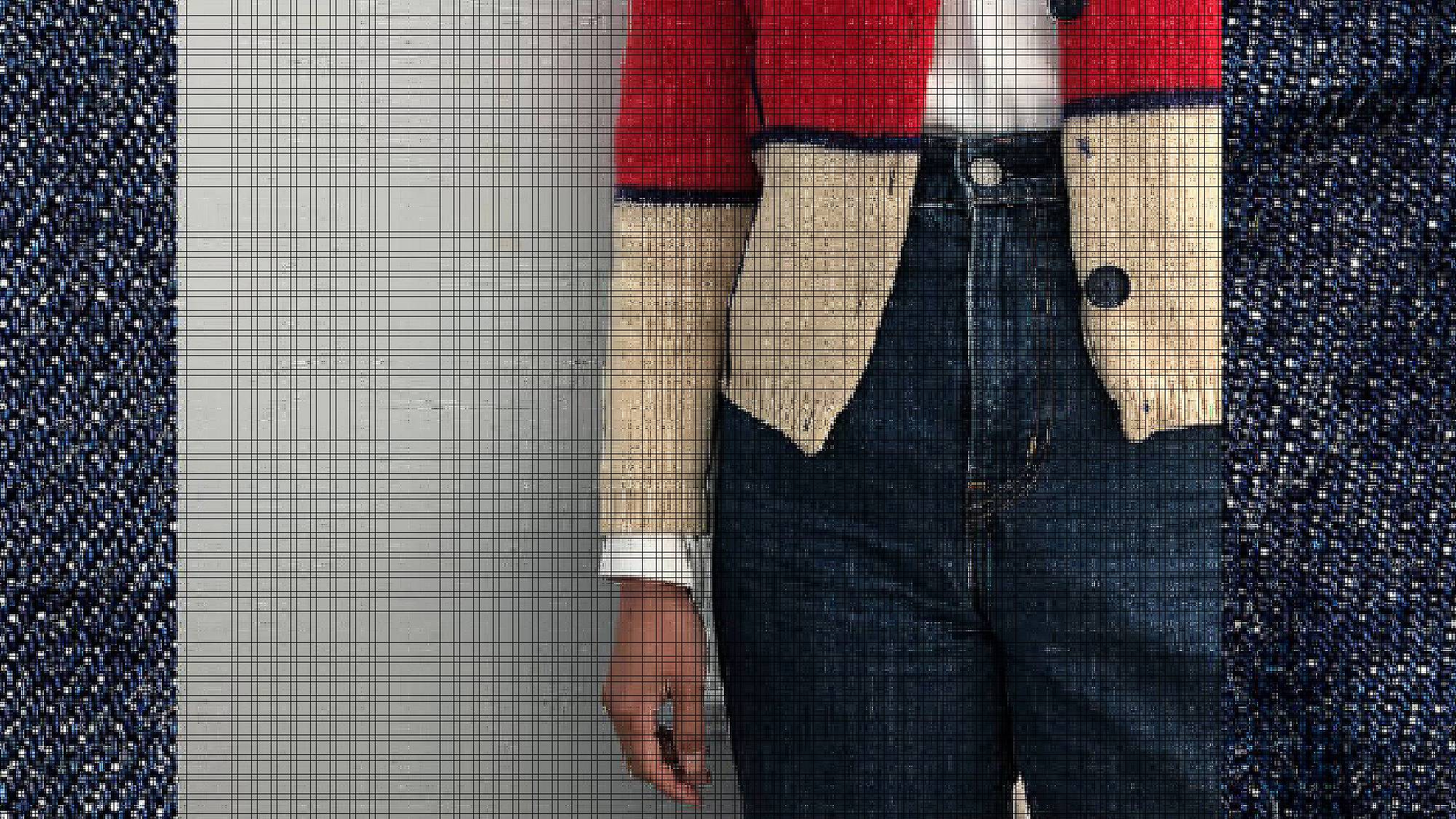 Close-up photo of Victoria Cao's red and cream cardigan and Levi's jeans.