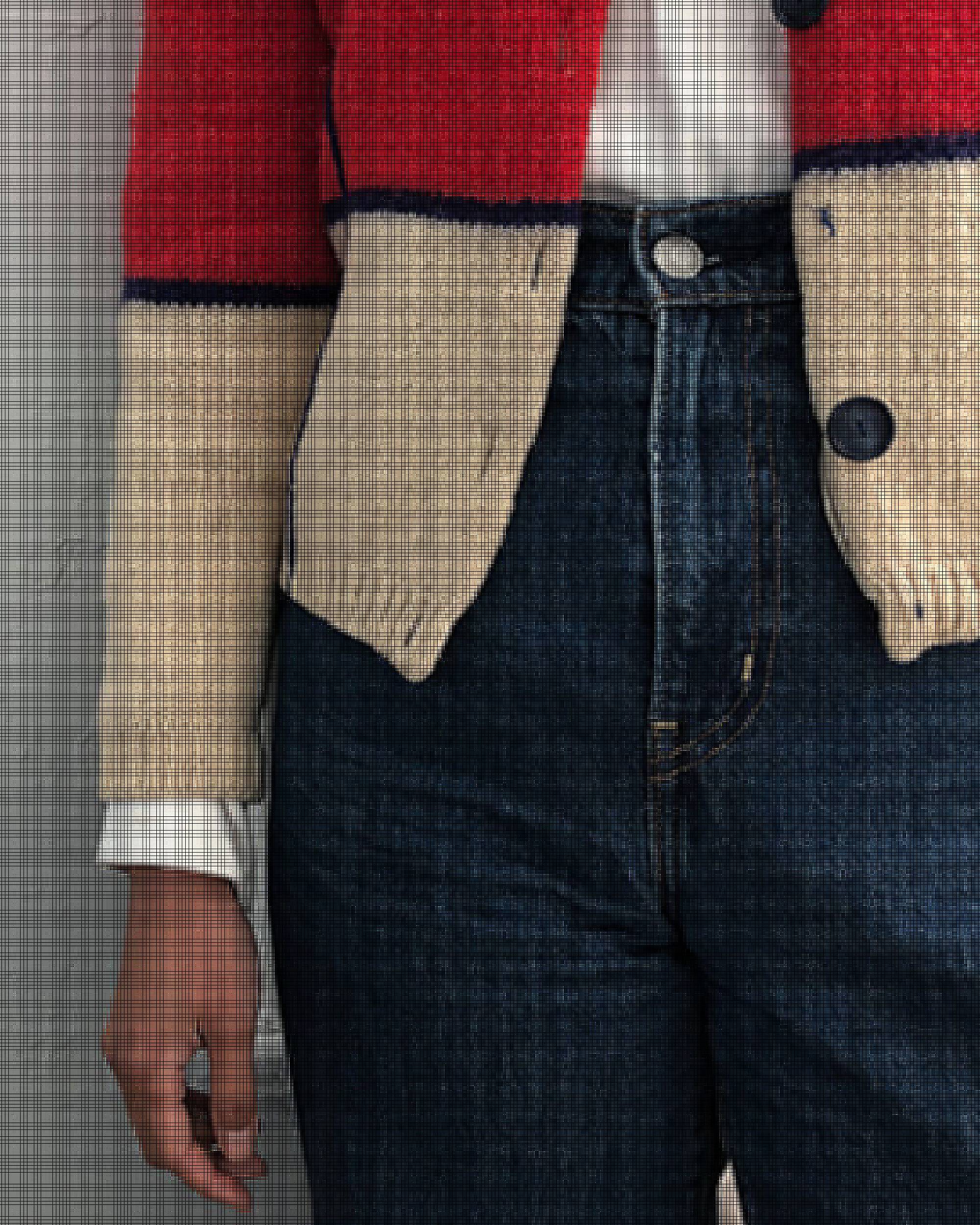 Close-up photo of Victoria Cao's red and cream cardigan and Levi's jeans.