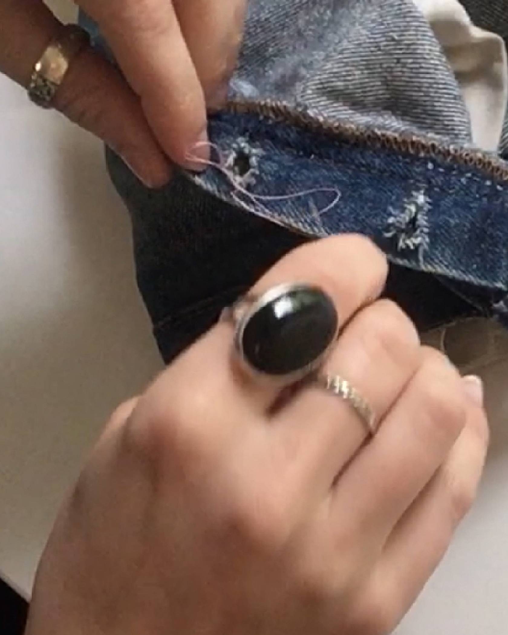 Image of the Levi's® Tailor creating a figure 8 stitch on the pair of jeans.