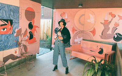 Portrait of Salomée Souag in a room with her murals.