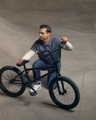 man in eco flex jeans with bike