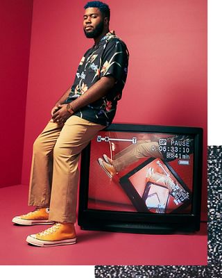 Khalid sitting on top of a tv