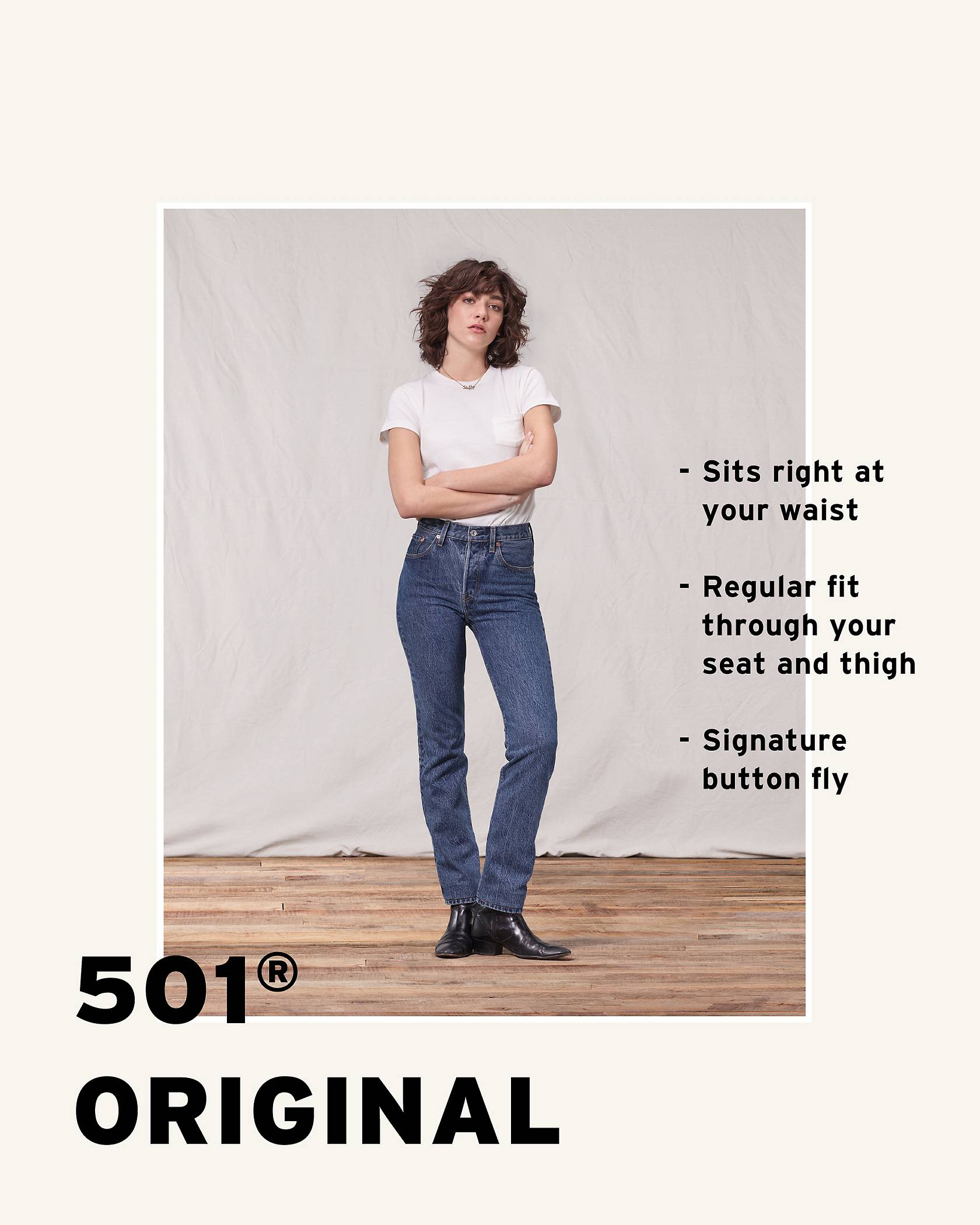 Model wearing a white tee shirt, medium wash 501® Original Jeans, while crossing her arms.