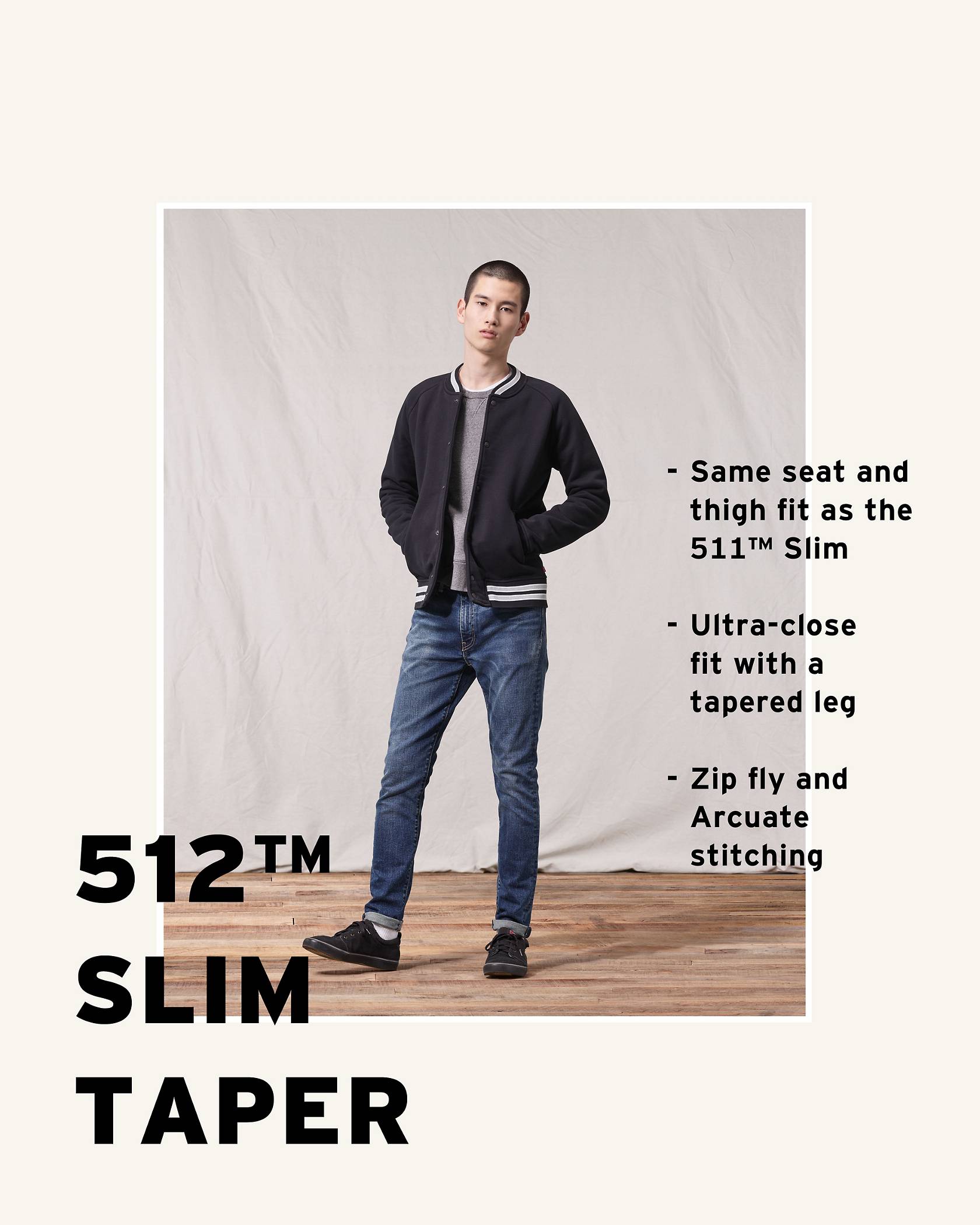Model wearing a black jacket and 512™ Slim Taper jean while putting his hands in his jacket's pockets and looking at the camera.