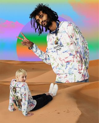 Two models sitting in the desert wearing pieces from the grateful dead collaboration