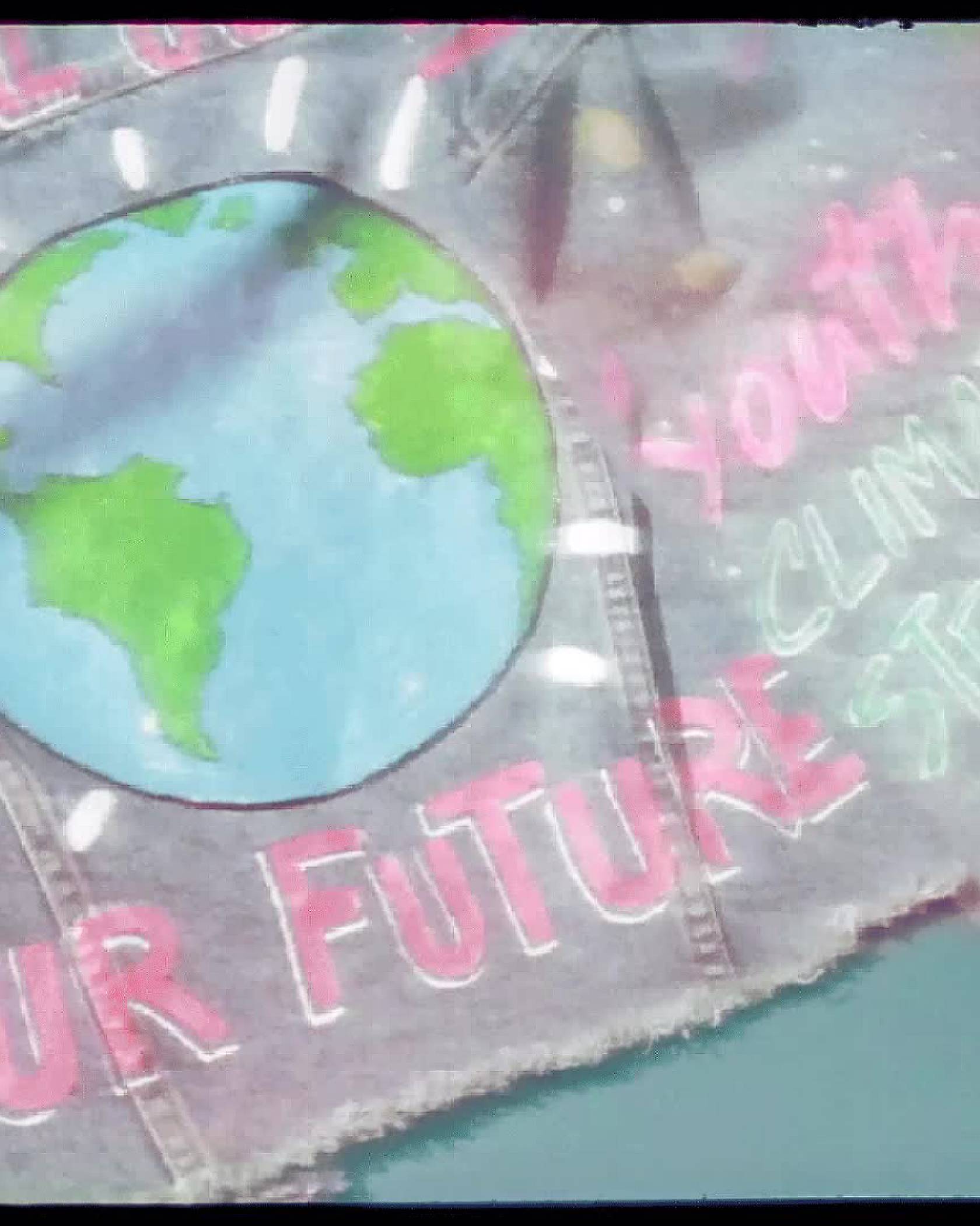 A gif of the back of Xiye's custom Levi's Trucker jacket showing the painted on words, "Climate Justice is Social Justice", "Our Future", and "Youth Climate Strike" additionally the back of the jacket features a painting of the globe.