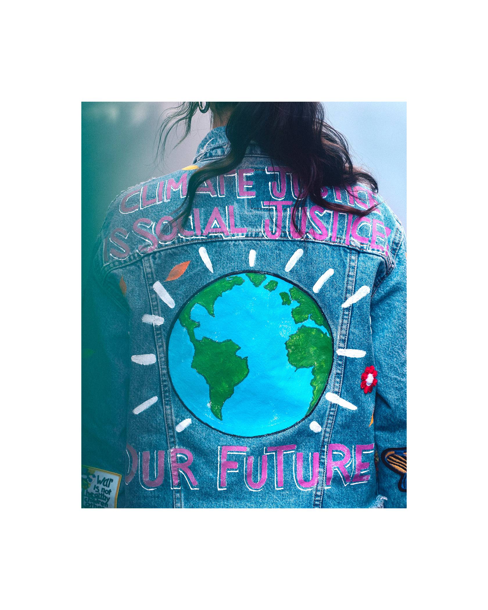The back of Xiye's custom Levi's trucker jacket that has the words, "Climate Justice is Social Justice" and "Our Future" and a picture of the globe.