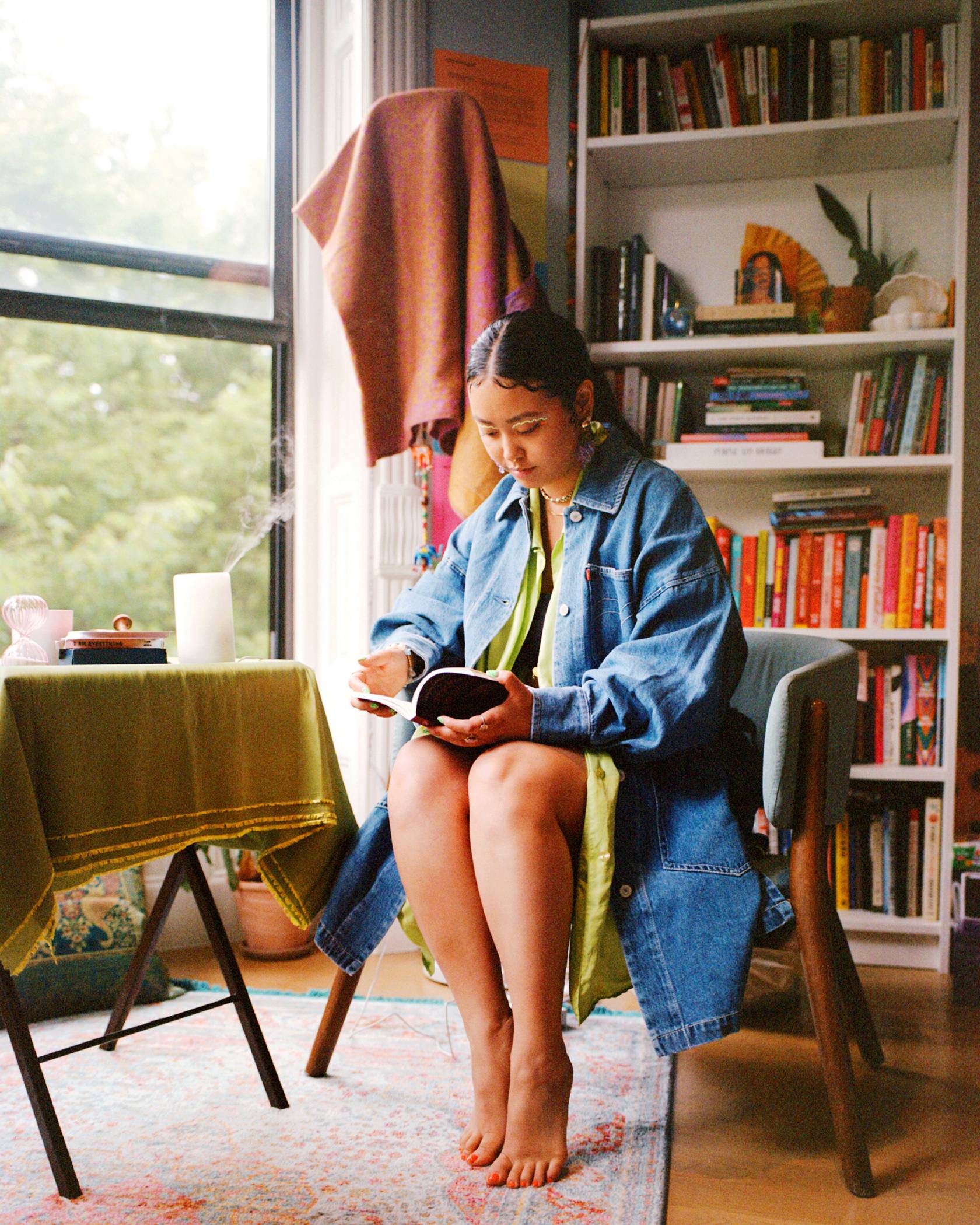 Jezz Chung reading a book in a levis denim button up western shirt