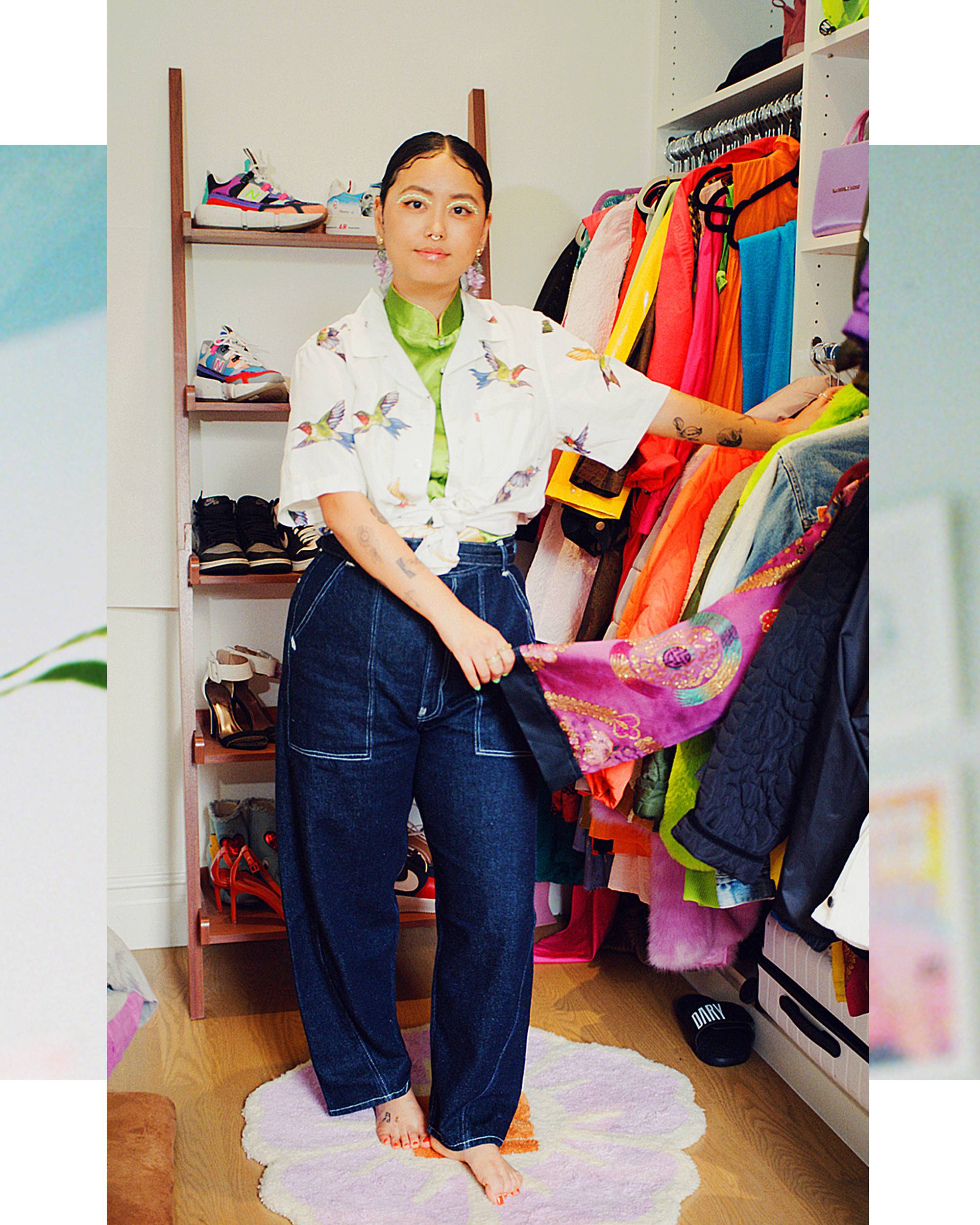 Jezz Chung in her closet looking through clothing, styled in high wasted Levis denim jeans in dark blue