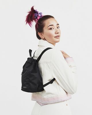 girl carrying black backpack