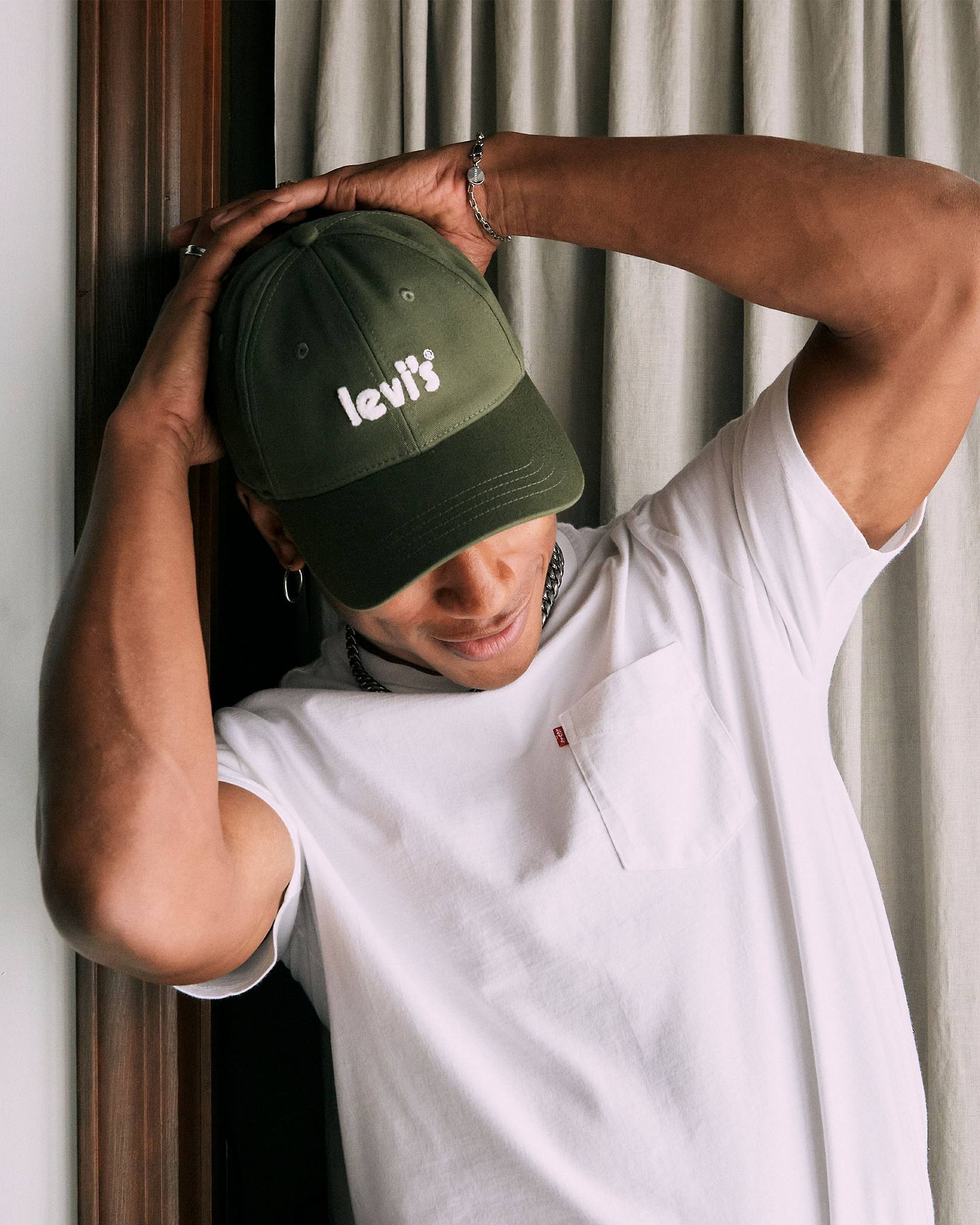 Back to School Shopping featuring Perris Howard in a white tee and forrest green baseball cap