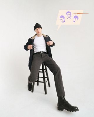 Gabe sitting on a stool against a white backdrop wearing black chinos, white tee, beanie and dark wash denim jacket with an illustrated thought bubble