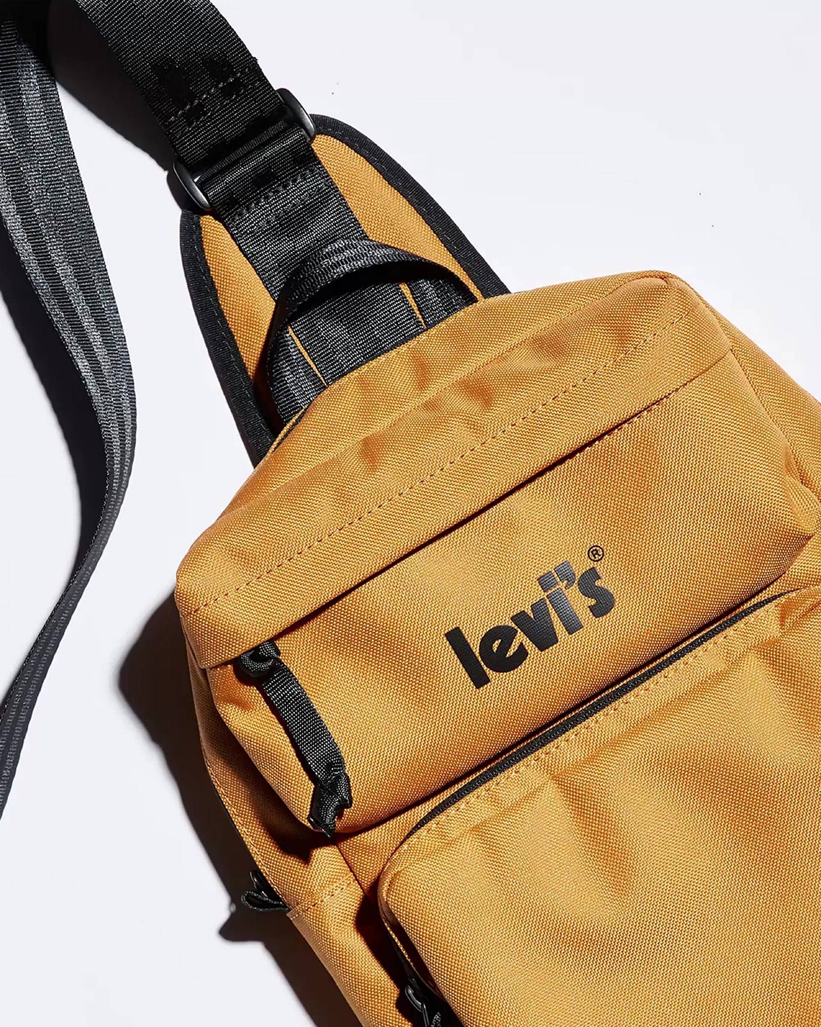 Levis Logo shoulder bag in gold with black levi's logo on front zip pocket