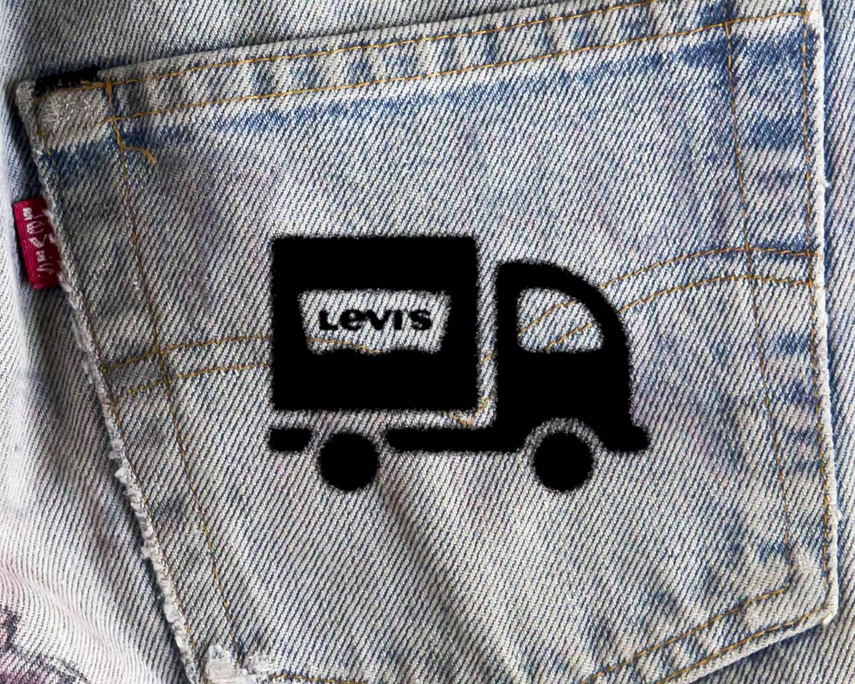 Animated shipping truck icon over top of a light wash jeans image