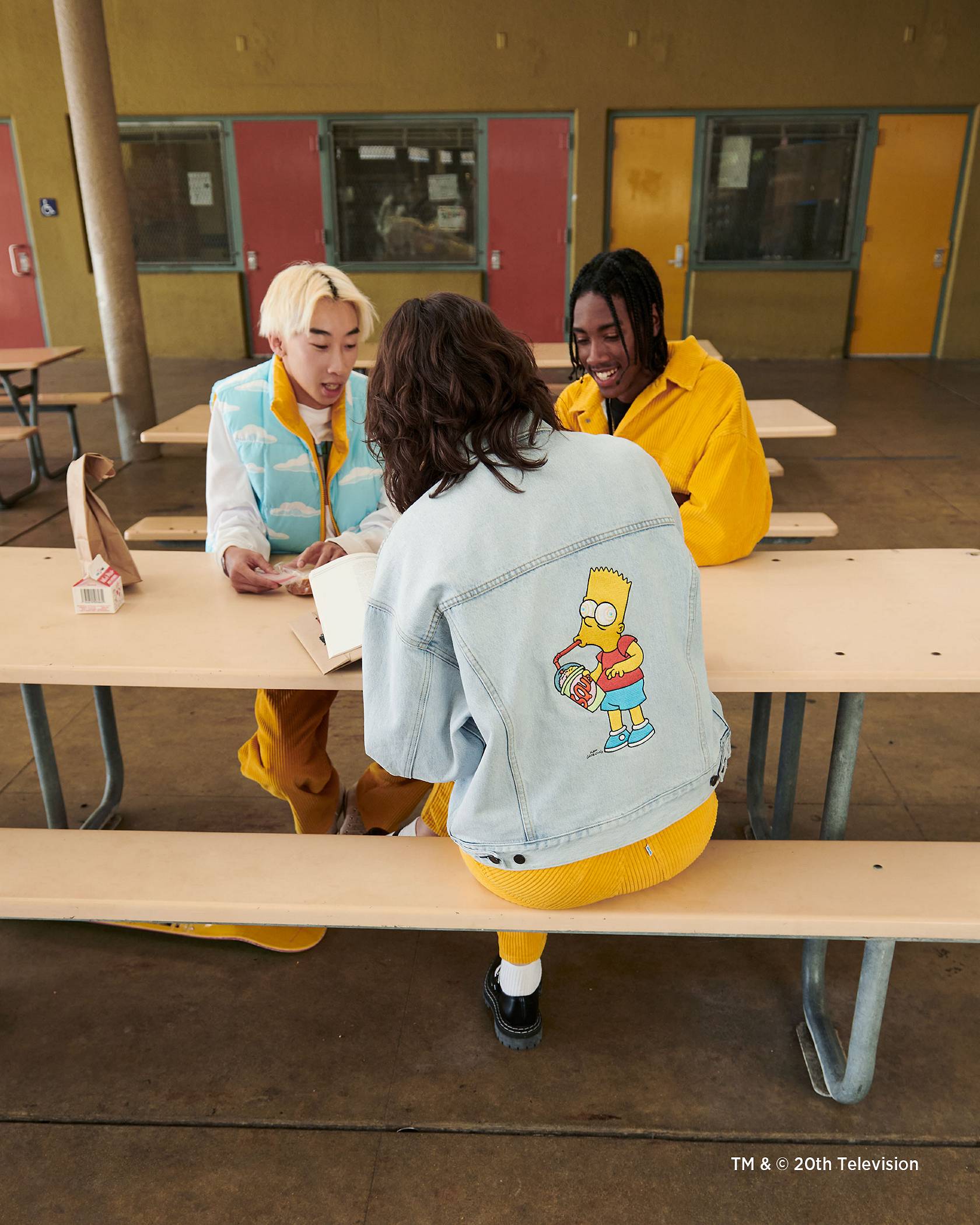 Image of people sitting at lunch table in clothing