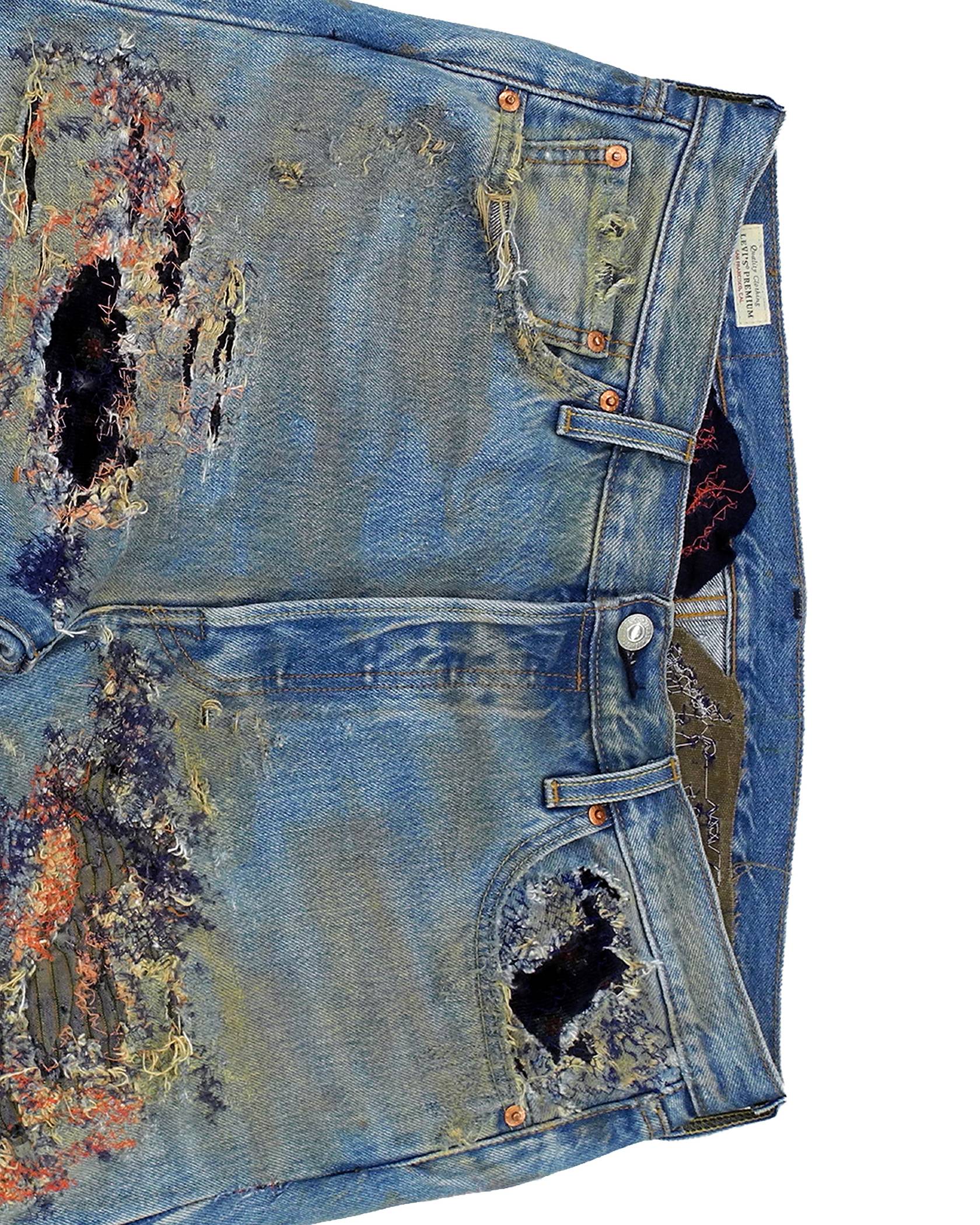 Phillip Leyesa close-up on the front waist zipper and buttons to the Levi's 501 Jeans after his customization process showing detailed distressed effect.