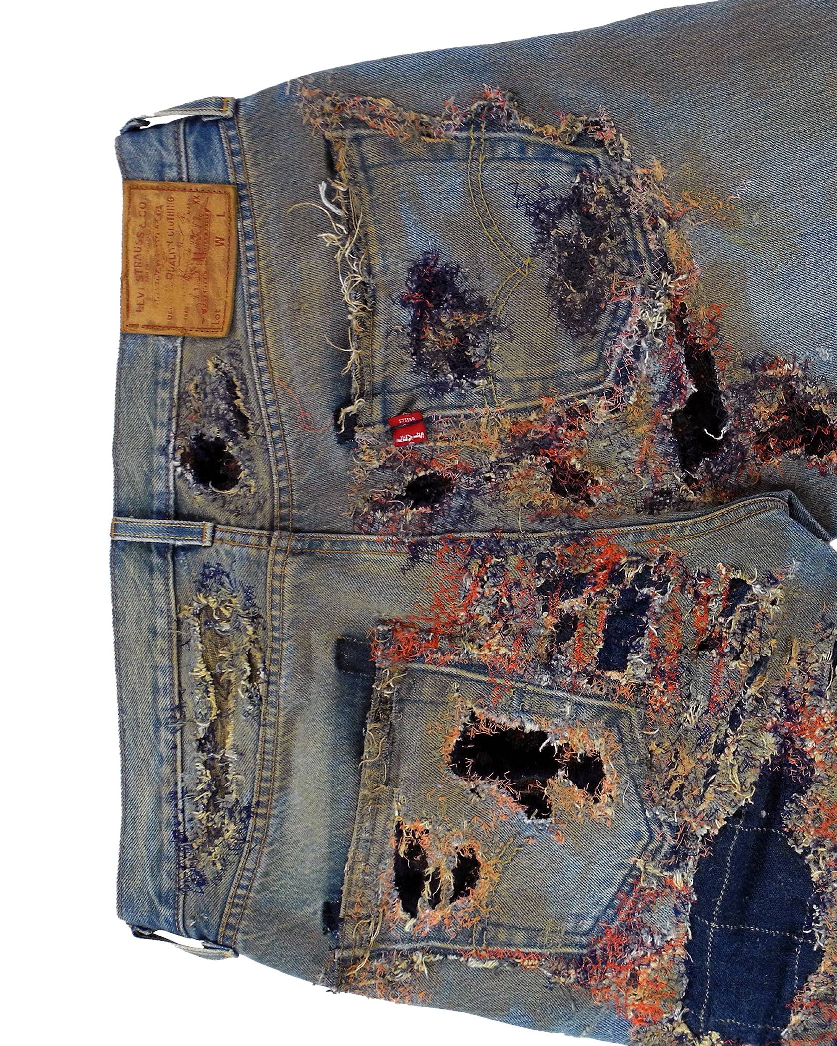 Phillip Leyesa close-up on the backside waistline and back pockets with Levis brand patch and red tab logo still on the Levi's 501 Jeans after his customization process showing detailed distressed effect.