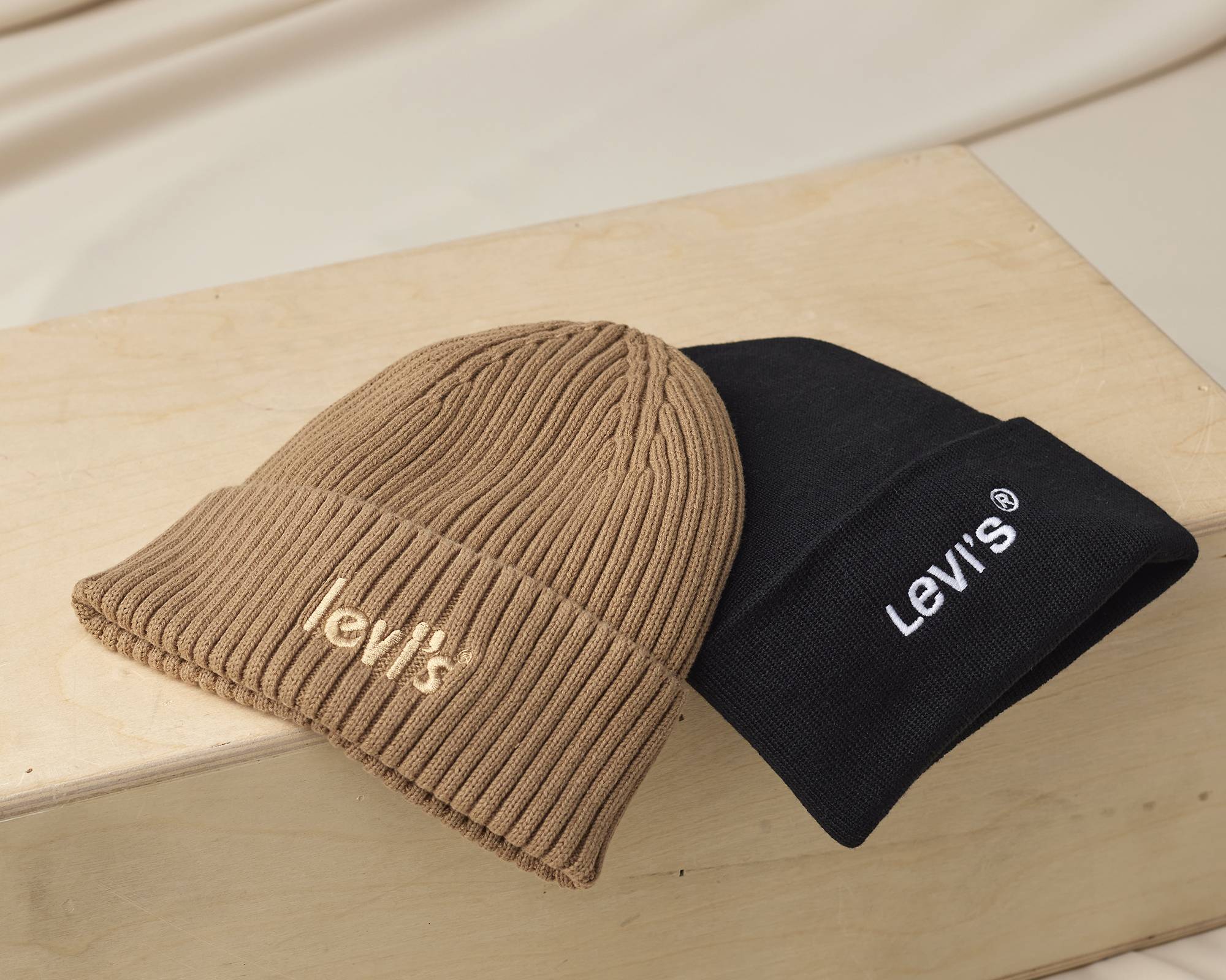 Laydown of a brown and black beanie.