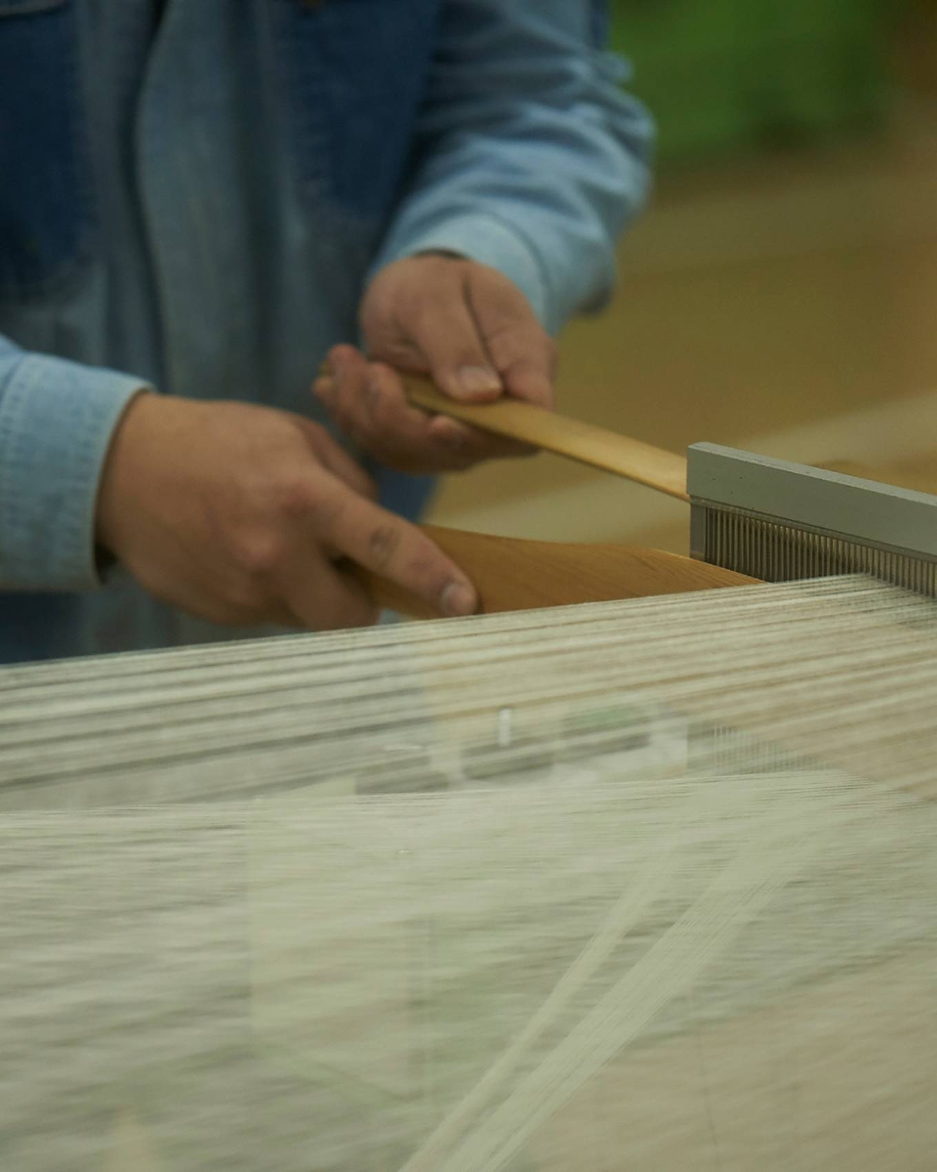 Levi’s® Made & Crafted® showing processes of Kaihara denim plant worker with shuttle looms close up.