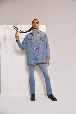 Model wearing denim jacket, striped turtleneck, and blue jeans