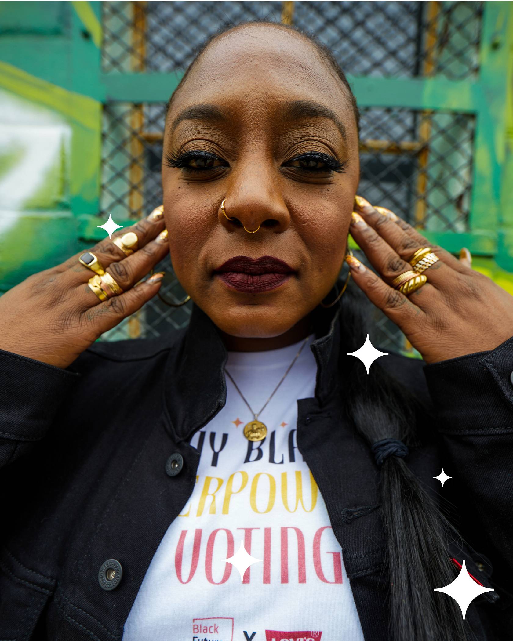 Alicia Garza holding her hands by her face.