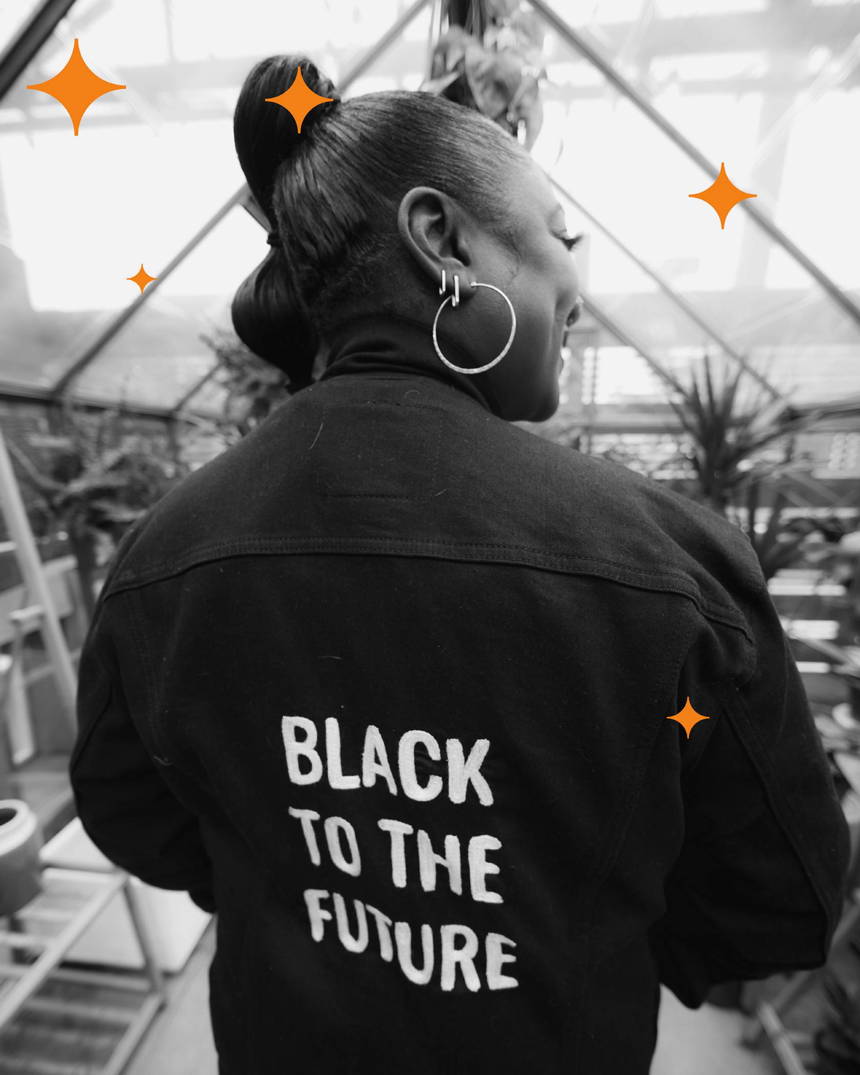 Alicia Garza wearing black to the future jacket.