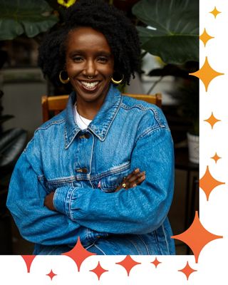 Nwamaka Agbo standing with arms crossed.