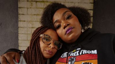 Two women hugging each other.