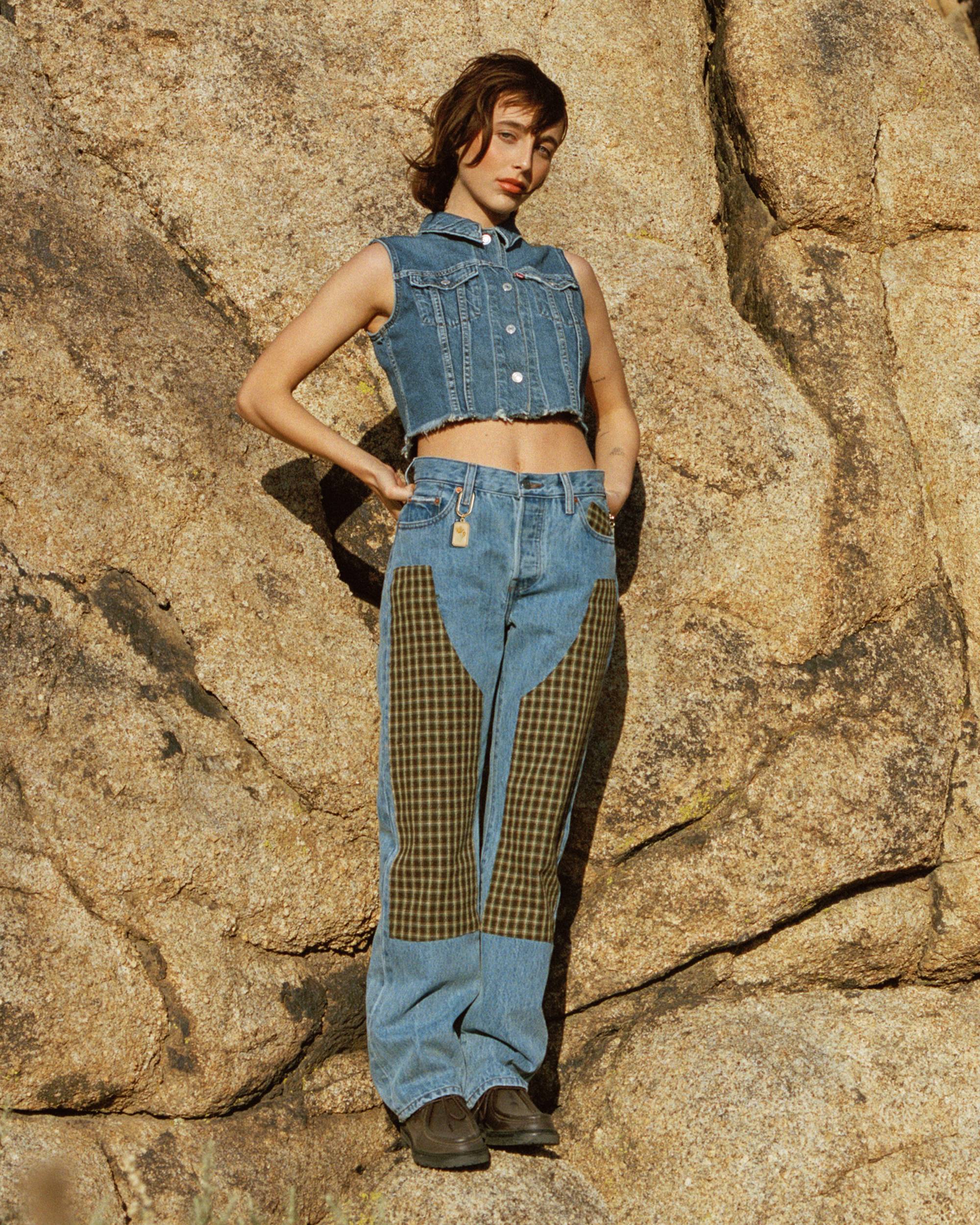 Image of Emma Chamberlain wearing the Levi's® x Emma Chamberlain collaboration against a rocky backdrop