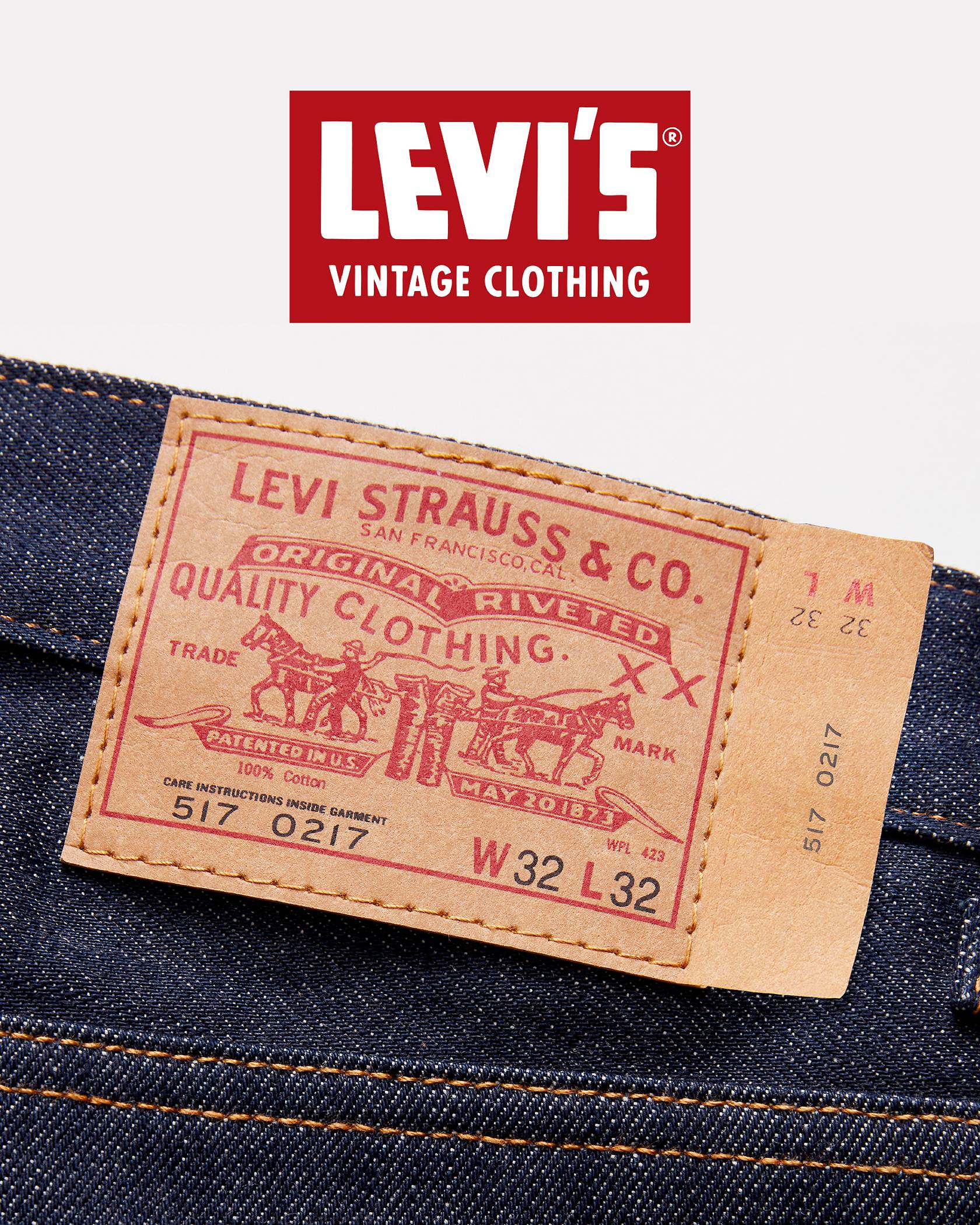 Vintage black and white photo of Levi Strauss holding a pair of jeans.