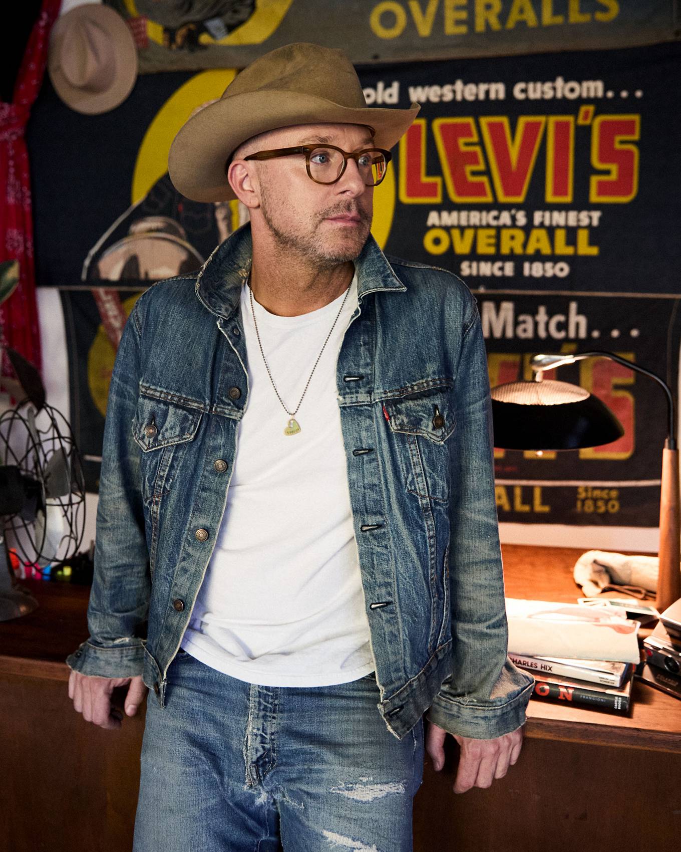 Mark Avery standing against a wall of vintage Levi's® posters
