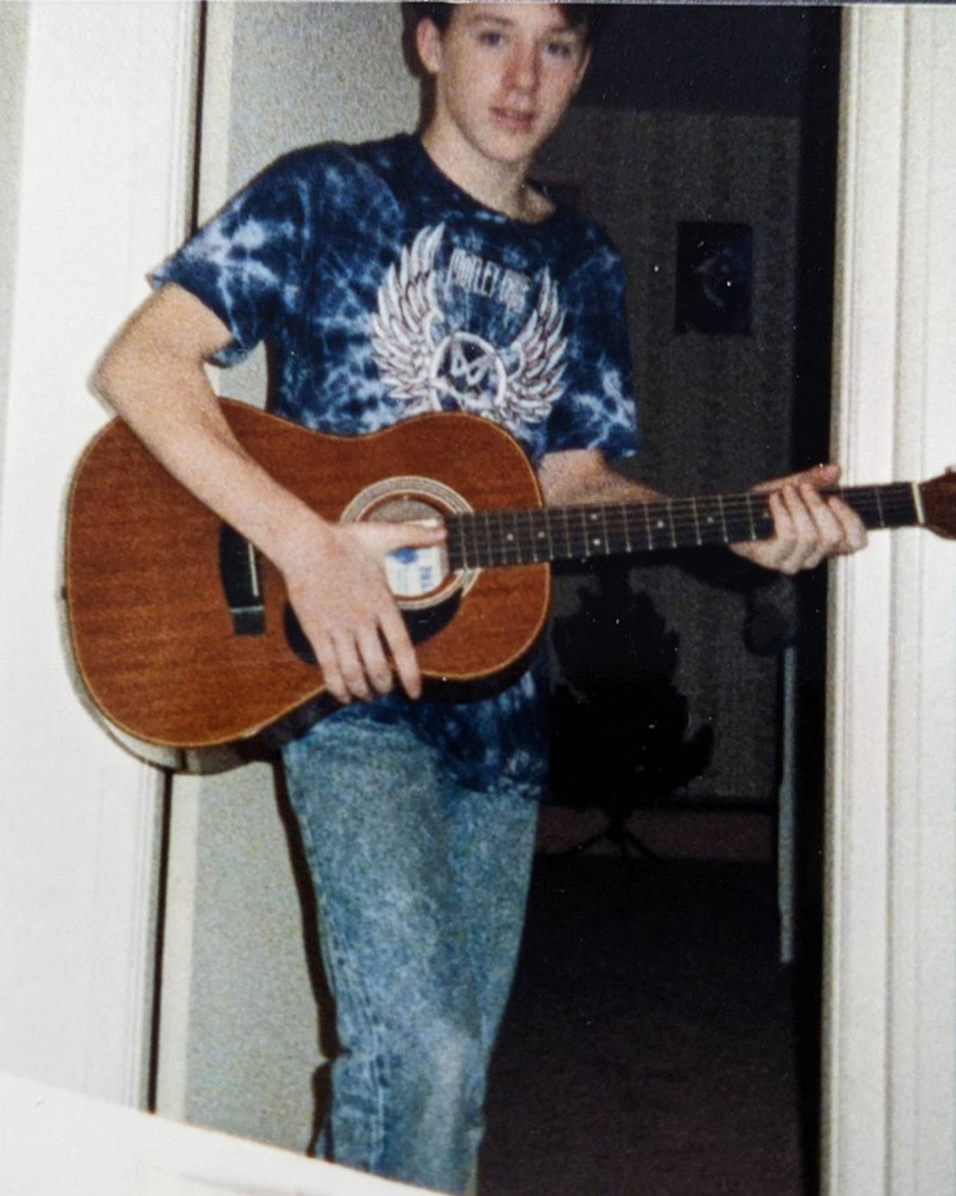 Mark Avery as a teen in 501® jeans holding a guitar