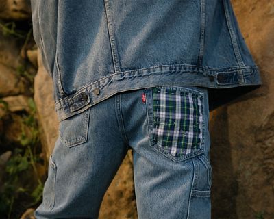 Closeup shot of model in Trucker Jacket and customized back pocket overalls