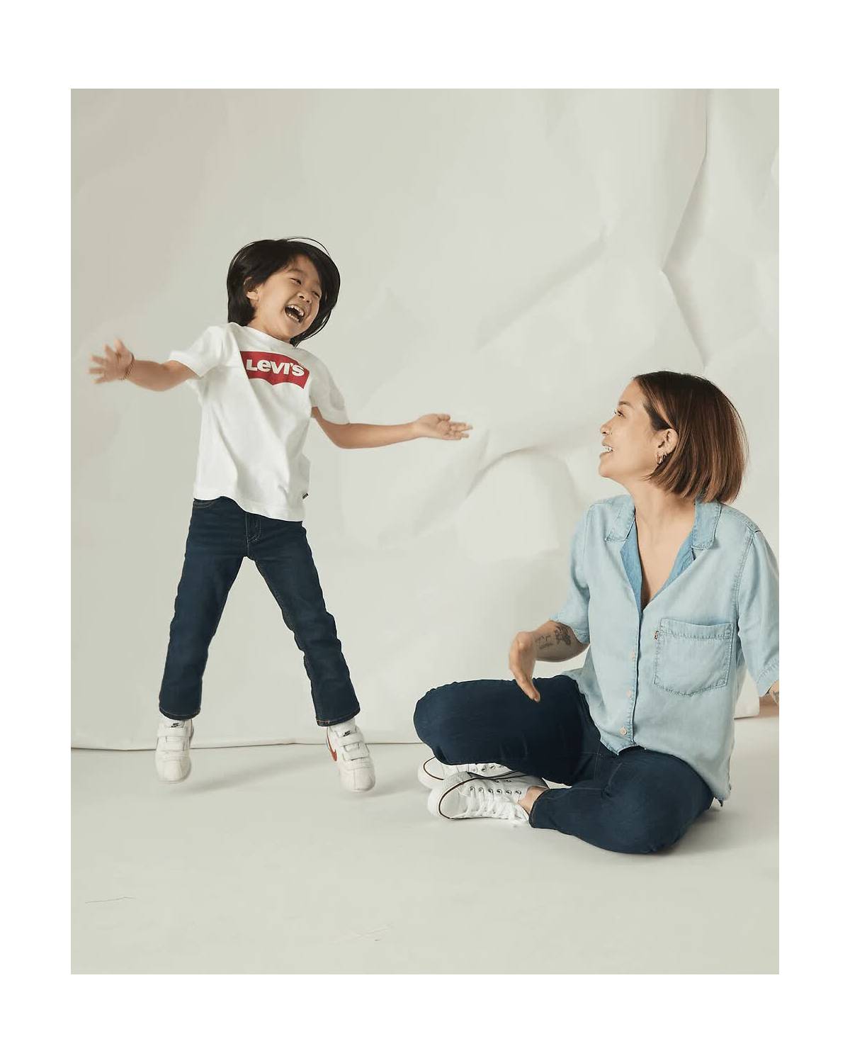 Rotating imagery of kid jumping next their mom in assorted Levi's styles
