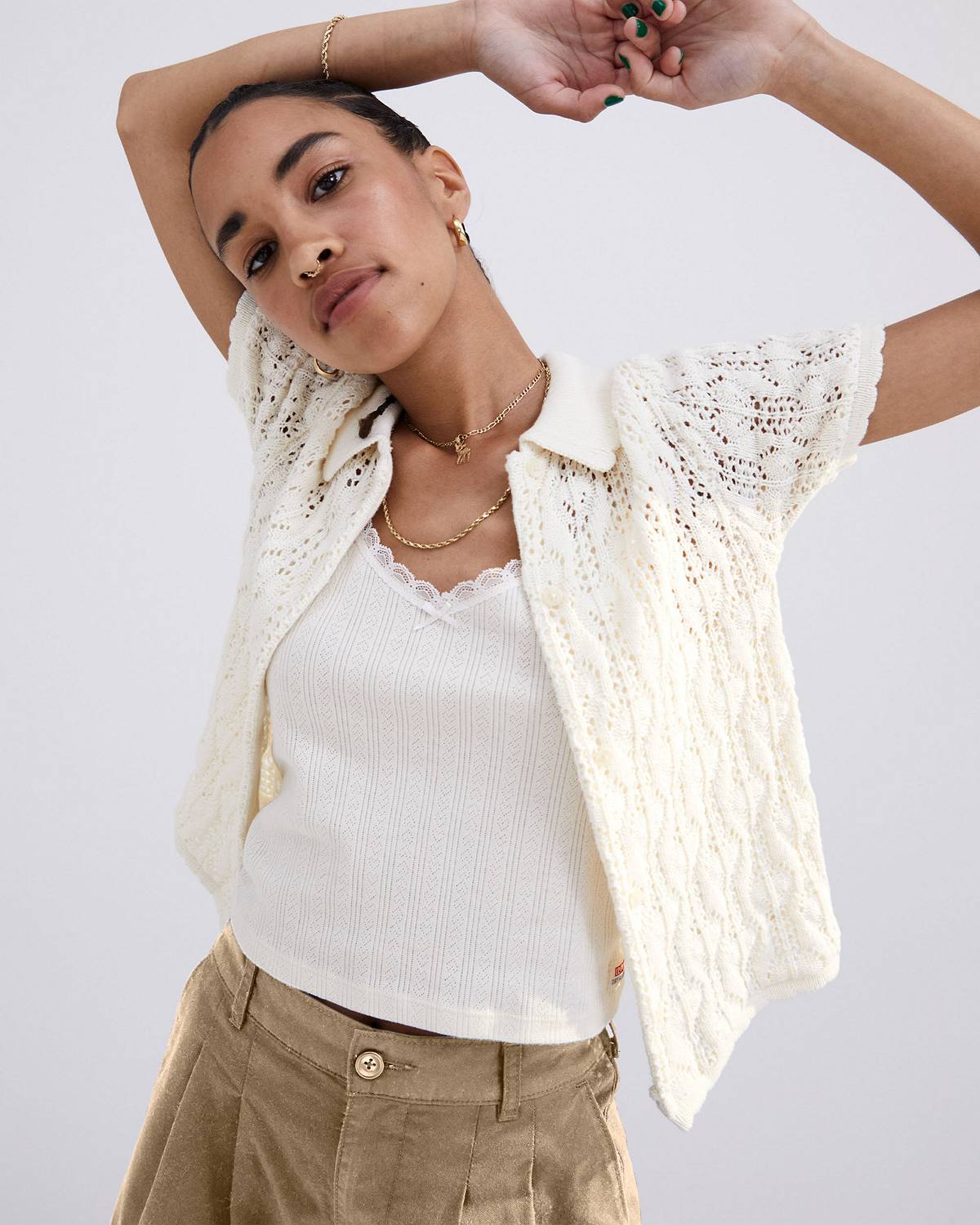 Model in white women's knit sweater shirt and tank