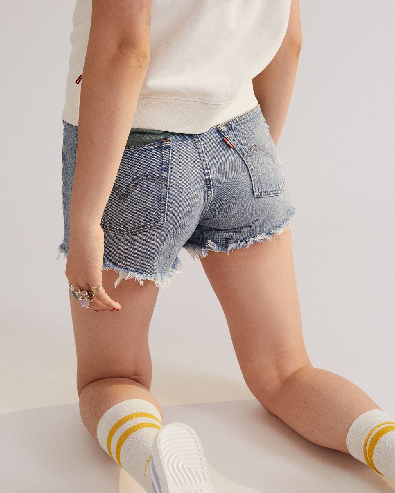 Model in women's cut off mini shorts