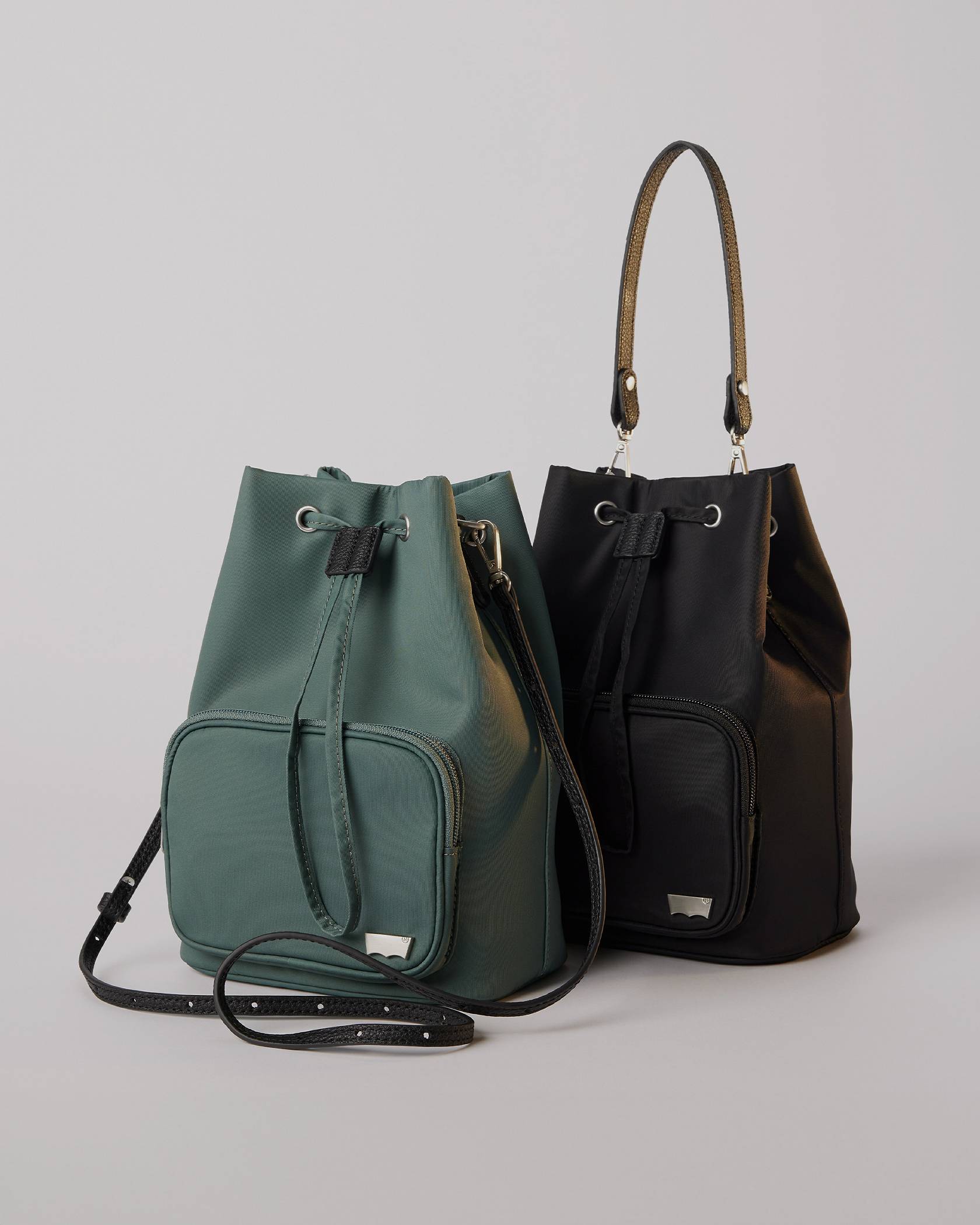 A green and a black bucket bag side by side