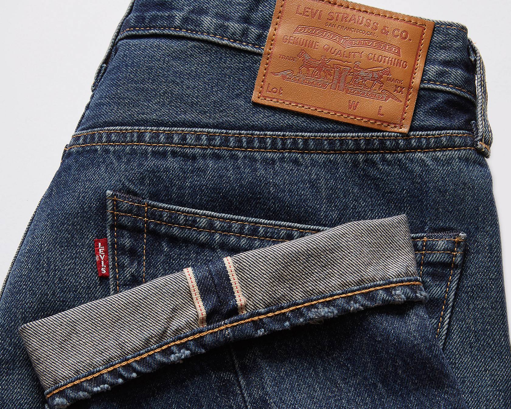 Closeup shot of selvedge jeans showing the signature ribbon stitching on the cuff