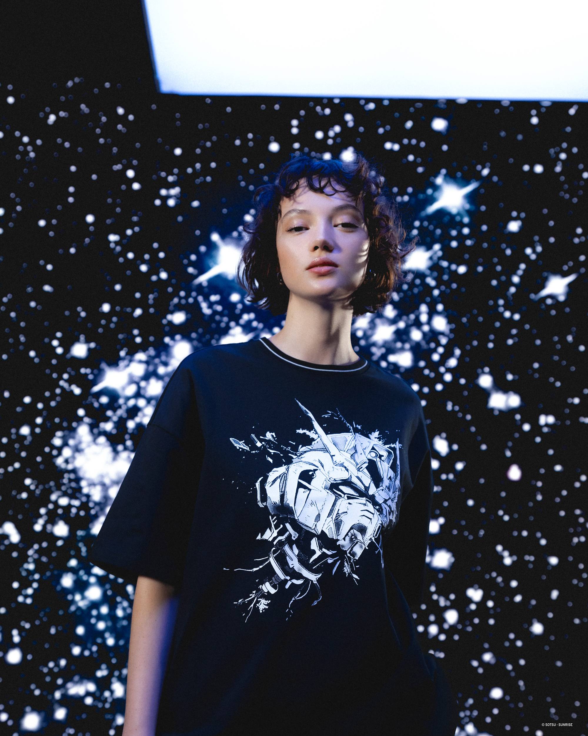 Image of woman wearing futuristic clothing and posing against dark and starry background
