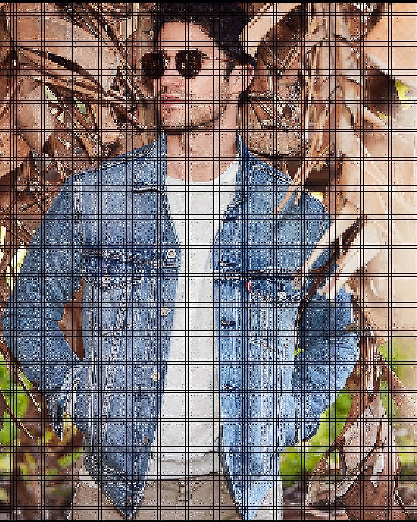 DARREN CRISS wearing a denim jacket and shades standing in front of a palm tree.