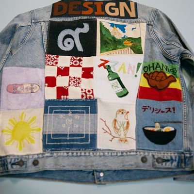 the back of a trucker jacket with a quilted design of different colored and patterned squares