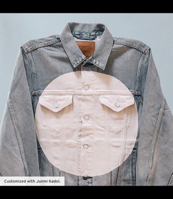 A custom trucker jacket featuring a white circle on the front and the outline of a black circle on the back