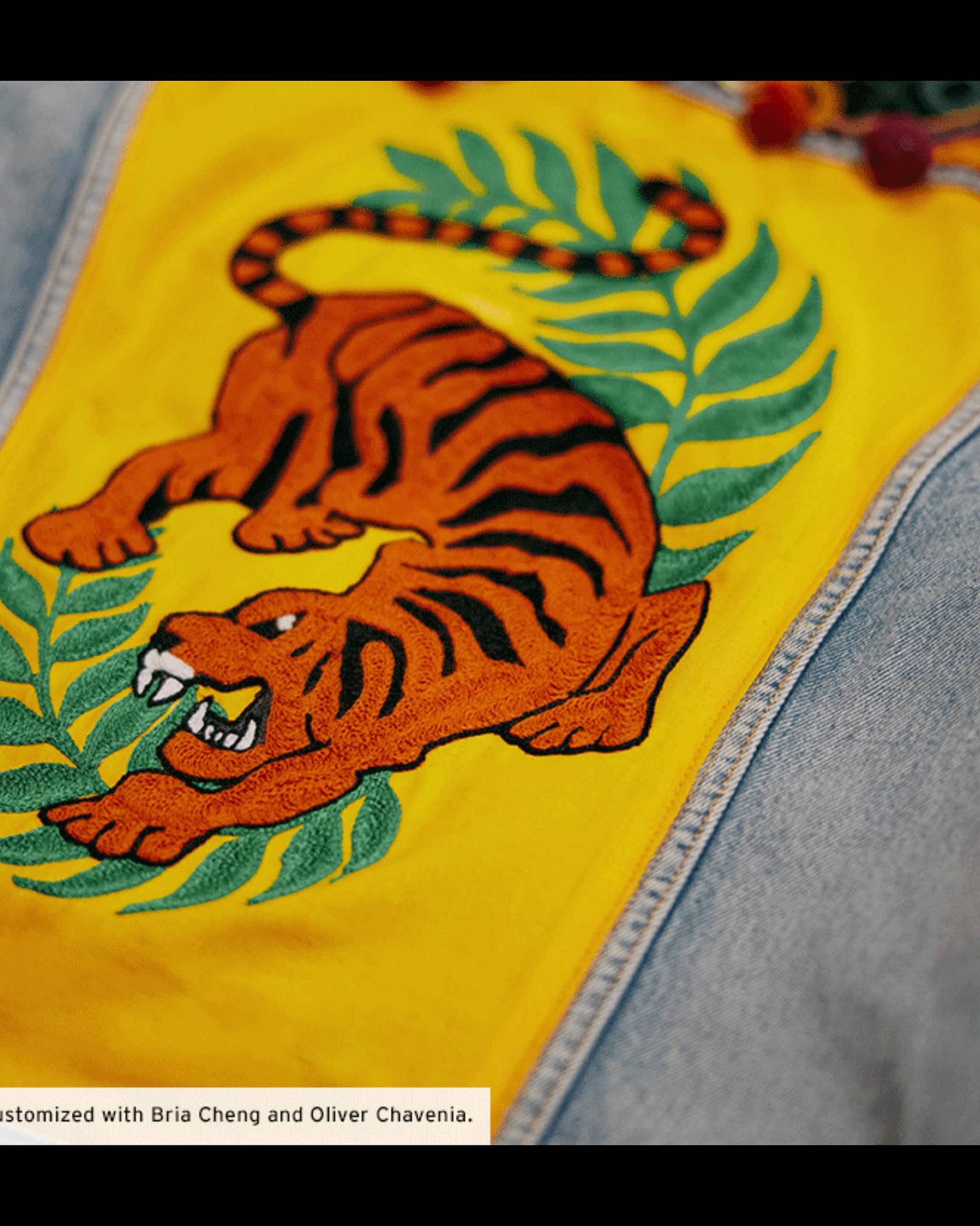 A customized trucker jacket featuring yellow background and a tiger