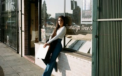 Photo of ABIR standing outside a record store.