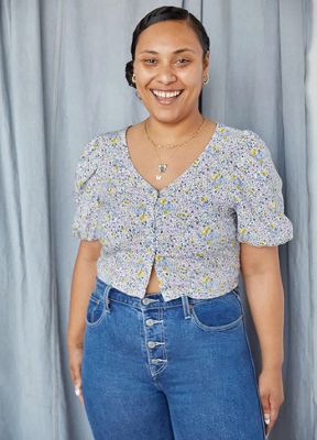 Video GIFing through three images of Levi's® employee Amber wearing a floral blouse, Wedgie jeans, and black boots.