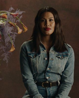 Leyna bloom sitting behind a golden frame