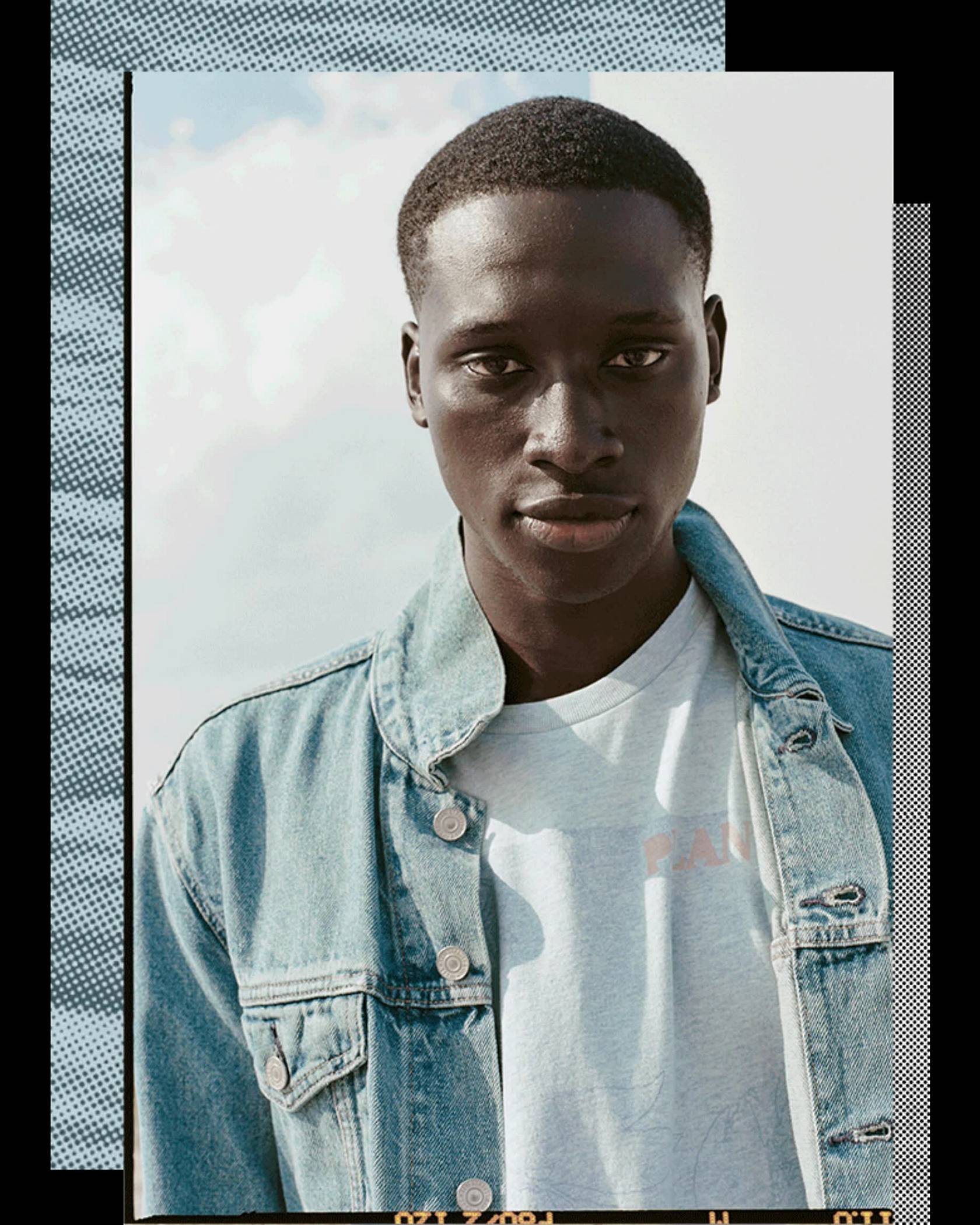 A portrait photo of a man wearing Levi's Wellthread jean jacket and a white tee